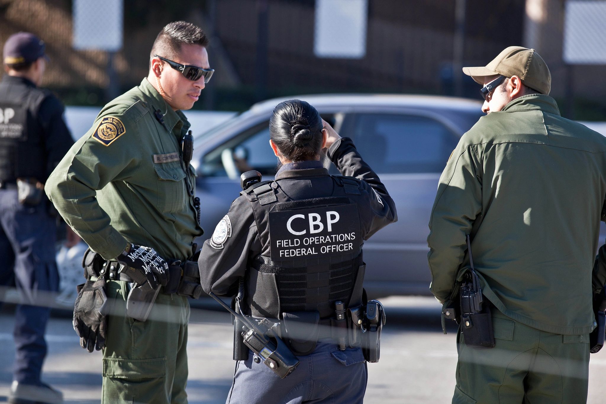 U.S. Customs and Border Protection officers standing together outdoors
