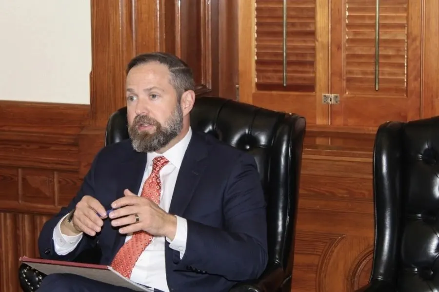 House Speaker Dustin Burrows seated in an office, speaking during an interview